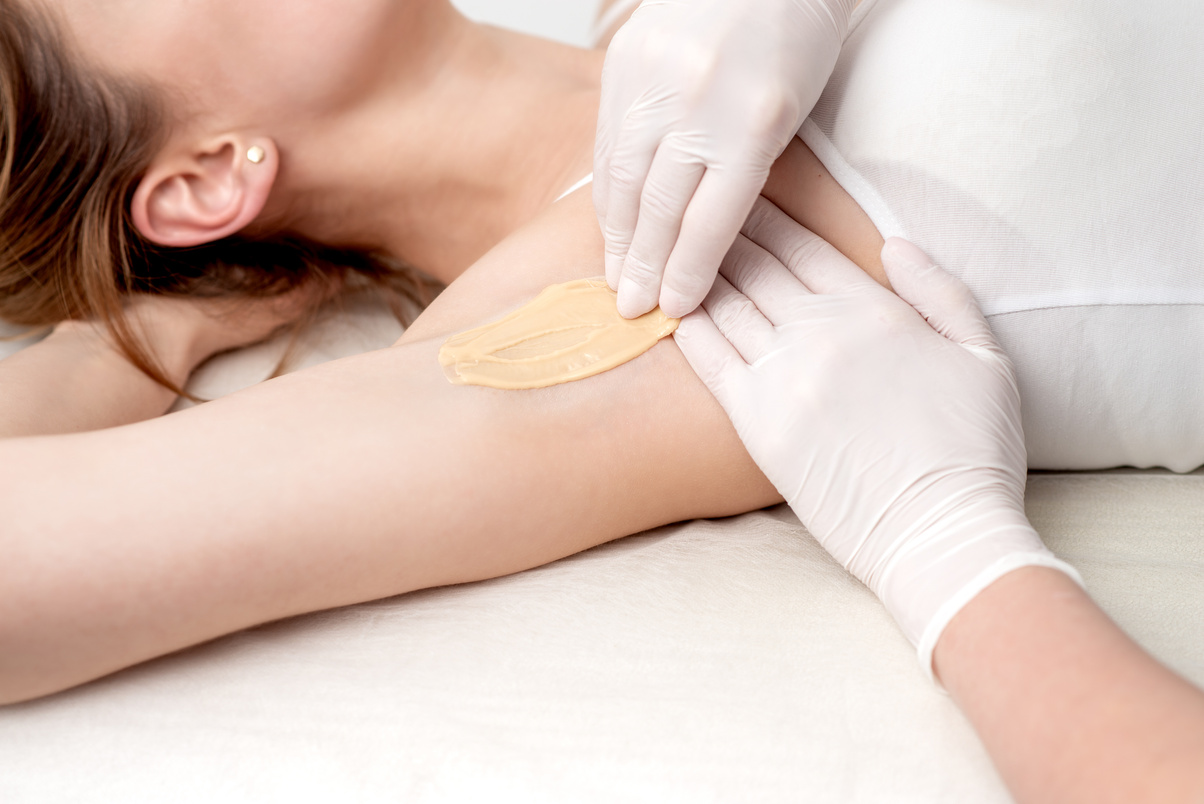 Cosmetologist Applying Wax Paste on Armpit